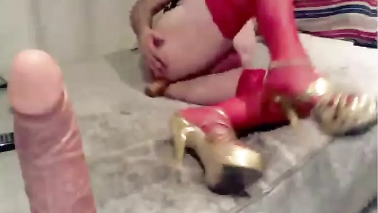 Sexy blonde sissy with high heels and stockins and a dildo